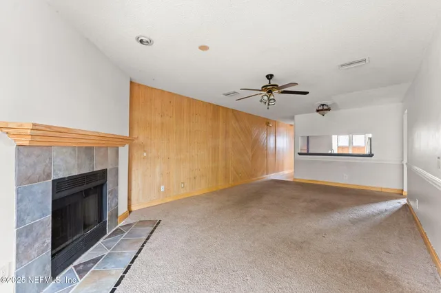 a view of a livingroom with a fireplace and cabinet
