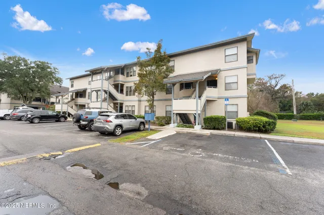a view of a cars park in front of a building