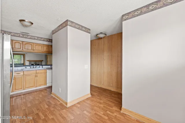 a view of kitchen with refrigerator and window