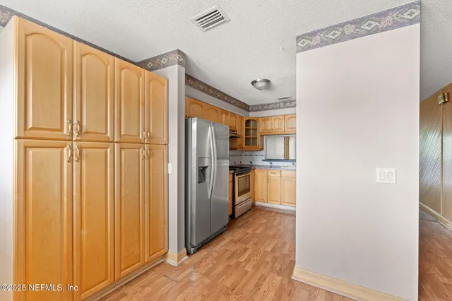 a kitchen with stainless steel appliances a refrigerator and cabinets