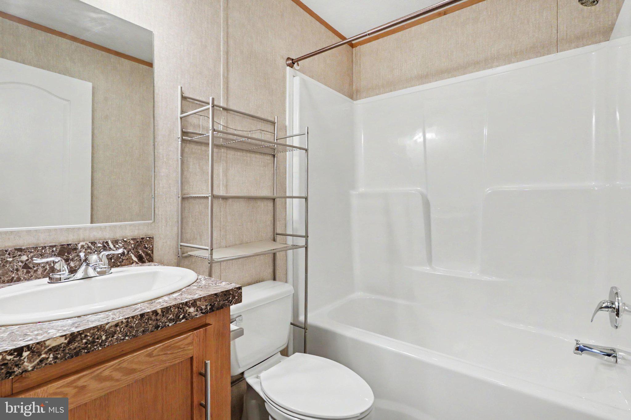 66 Kip Road Halifax, PA 17032 - Photo 11 of 16 a bathroom with a granite countertop sink toilet and shower