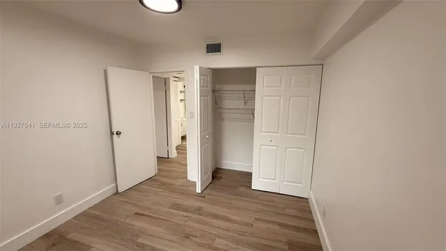 a view of a yard in front of a house with a large tree