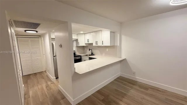a view of kitchen with wooden floor
