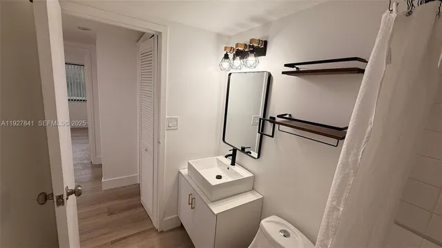 a bathroom with a sink toilet and shower