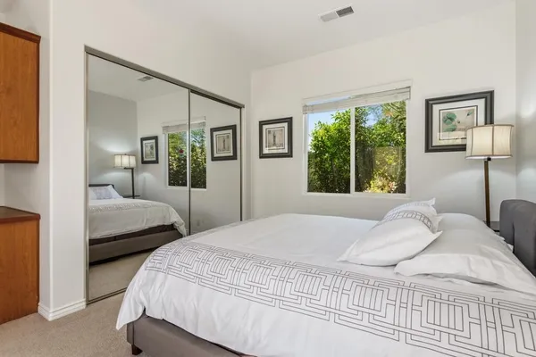 a bedroom with a large bed and a large window