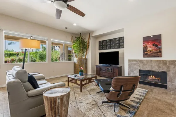 a living room with furniture a flat screen tv and a fireplace