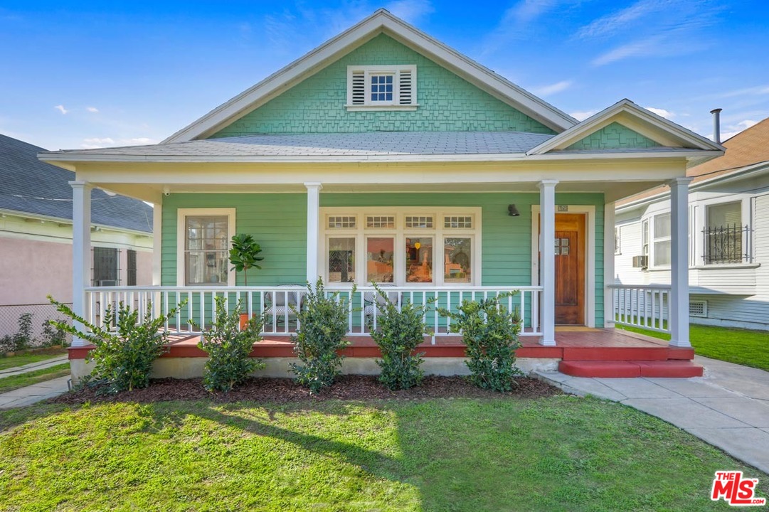 a front view of a house with a yard and porch