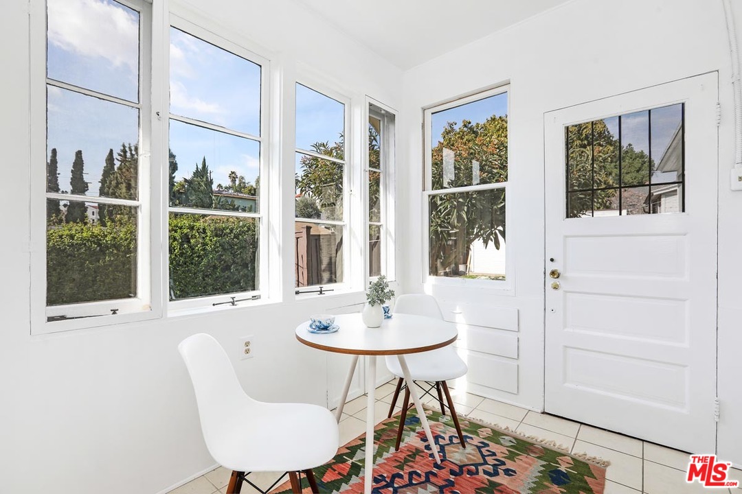 755 East Kensington Road Los Angeles, CA 90026 - Photo 12 of 25 a dining room with furniture and window