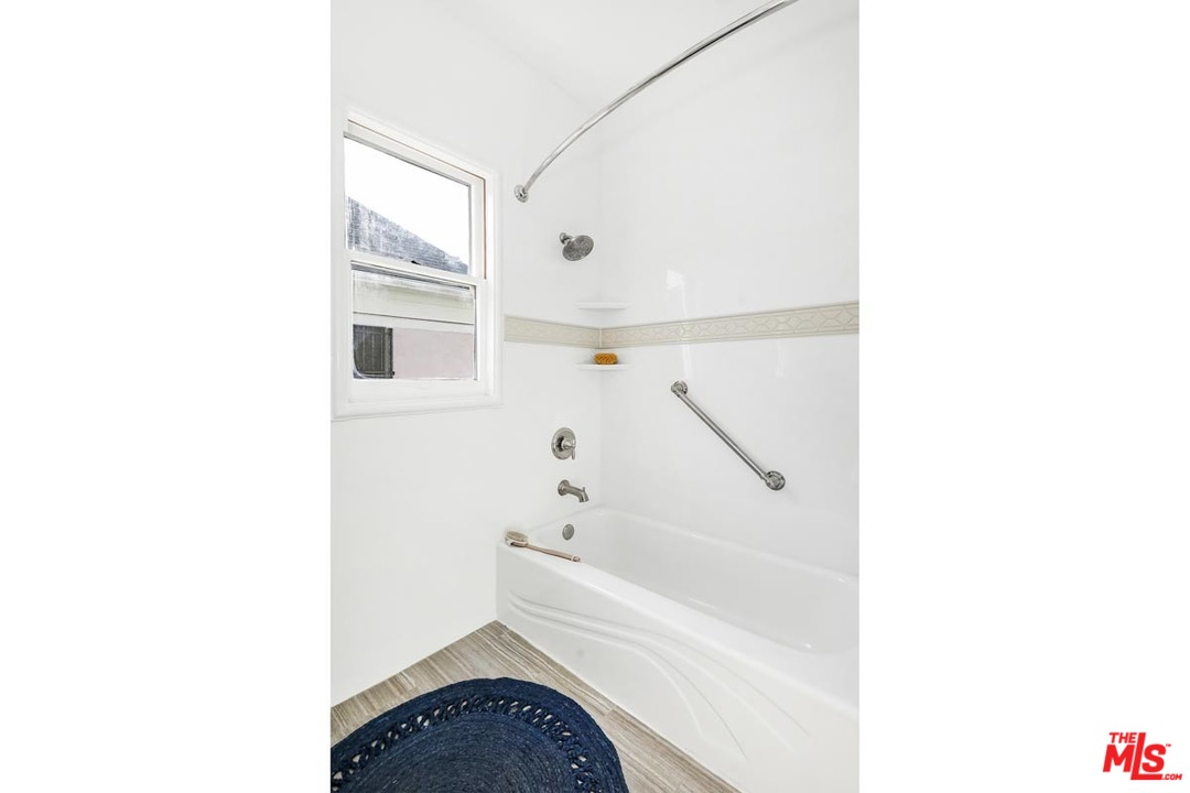 755 East Kensington Road Los Angeles, CA 90026 - Photo 19 of 25 a bathroom with a sink and a bathtub