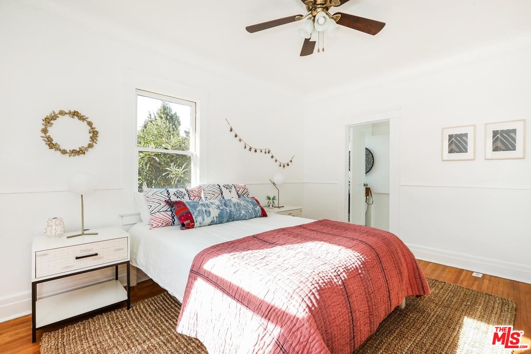 755 East Kensington Road Los Angeles, CA 90026 - Photo 20 of 25 a bedroom with a bed and a table