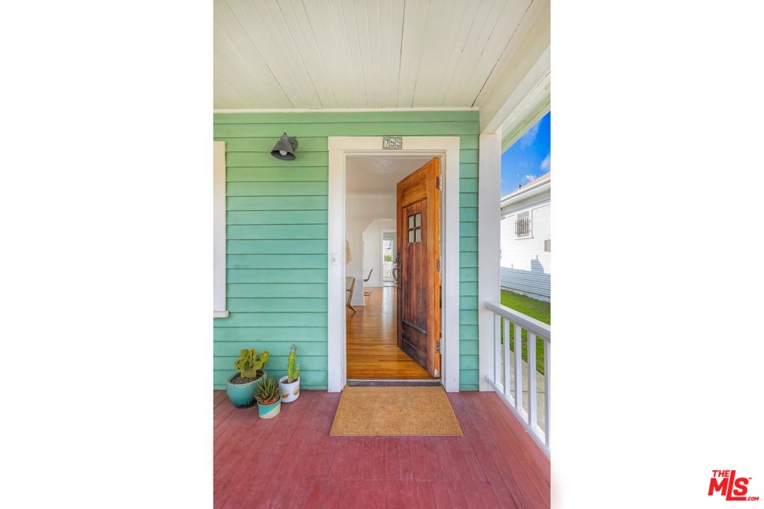 755 East Kensington Road Los Angeles, CA 90026 - Photo 3 of 25 a hallway with sliding door and stairs