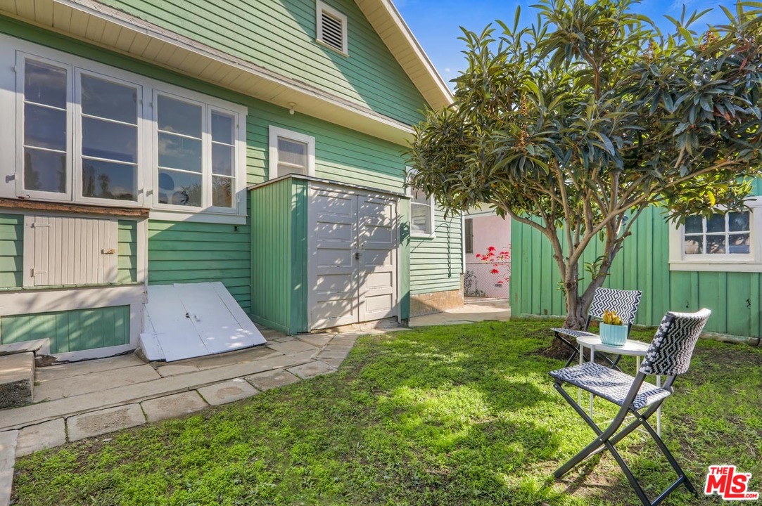 755 East Kensington Road Los Angeles, CA 90026 - Photo 24 of 25 a view of a chair and table in backyard of the house