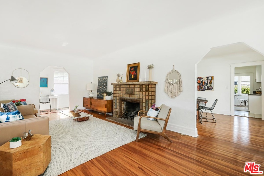 755 East Kensington Road Los Angeles, CA 90026 - Photo 4 of 25 a living room with furniture and a fireplace