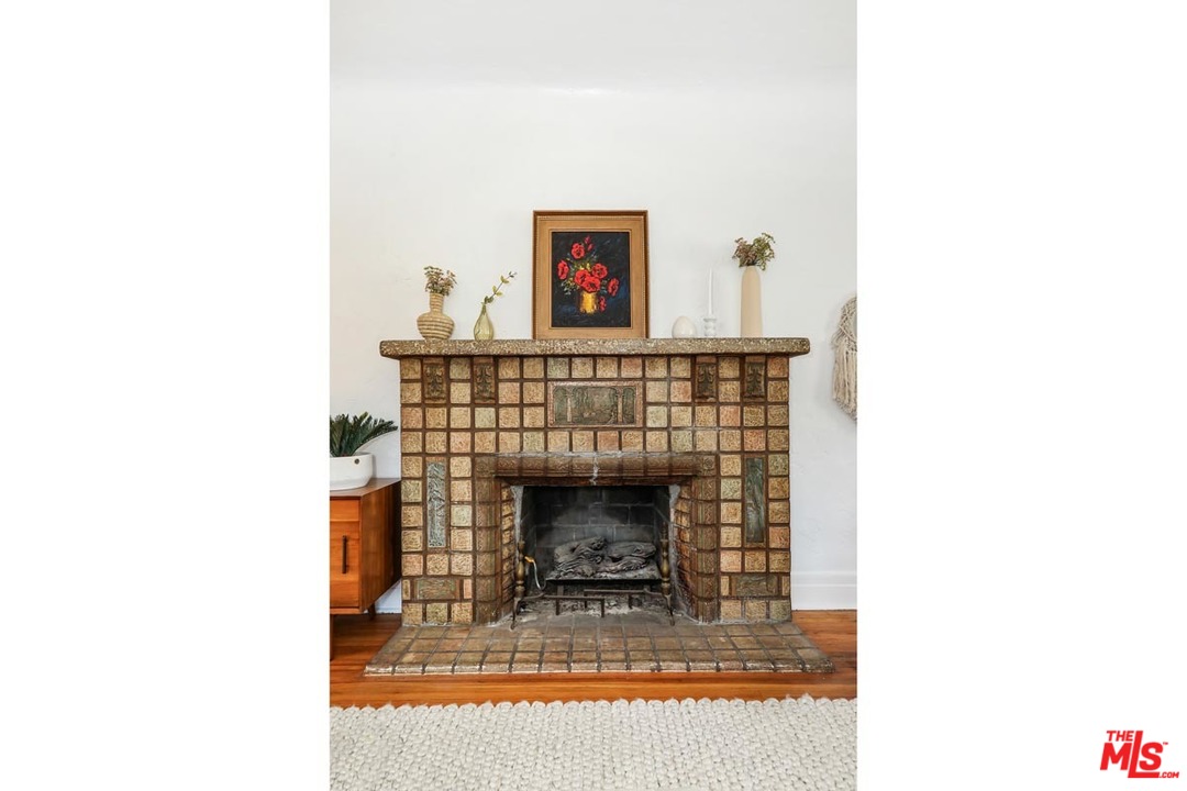 755 East Kensington Road Los Angeles, CA 90026 - Photo 7 of 25 a living room with a fireplace