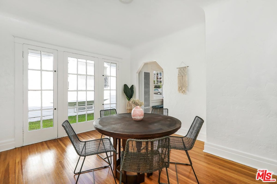 755 East Kensington Road Los Angeles, CA 90026 - Photo 9 of 25 a view of a dining room with furniture and wooden floor