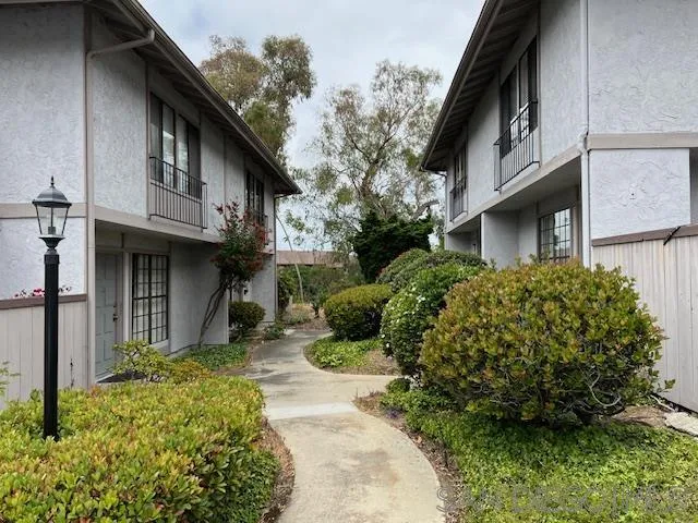 9564 Easter Way San Diego, CA 92121 - Photo 1 of 16 a view of a house with brick walls and flower plants