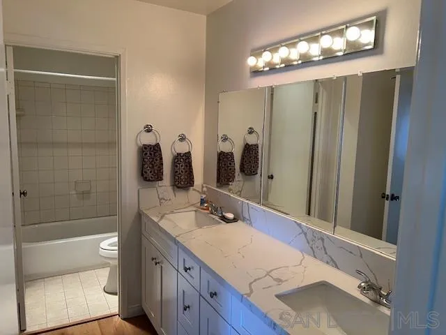 9564 Easter Way San Diego, CA 92121 - Photo 13 of 16 a bathroom with a sink double vanity granite tub and shower