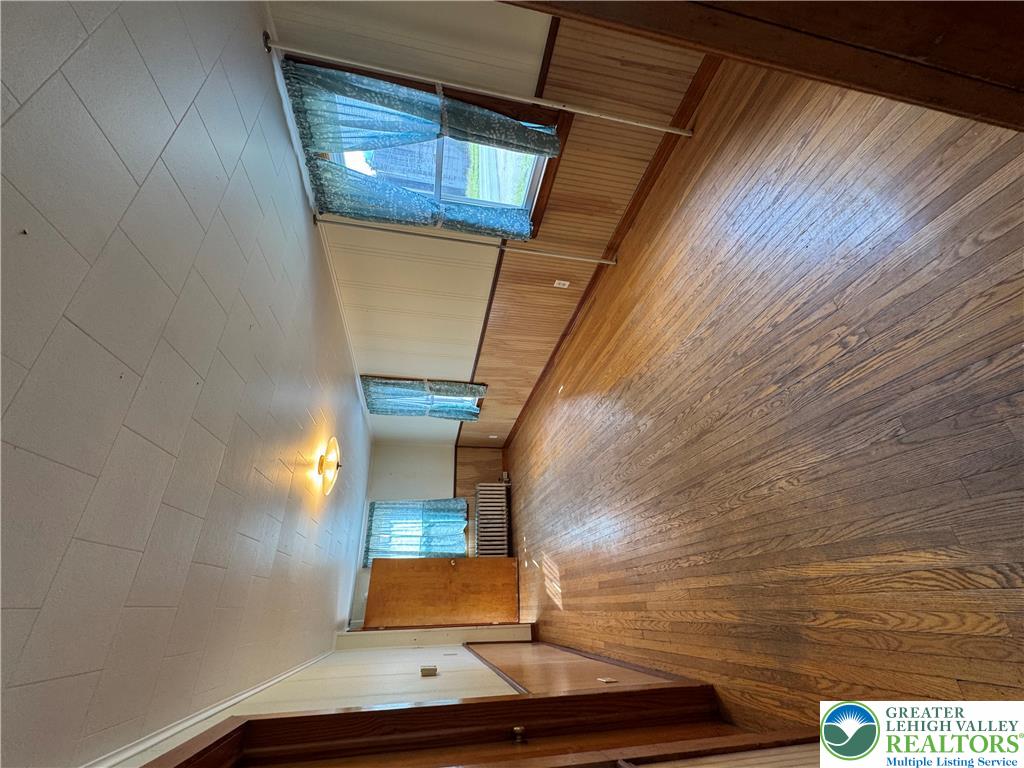 868 Catawissa Road Tamaqua, PA 18252 - Photo 31 of 67 Rich hardwood floors complement walls featuring both beadboard and painted textures.