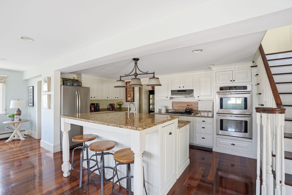 3 Talbot Road Hingham, MA 02043 - Photo 8 of 34 a kitchen with white cabinets and stainless steel appliances