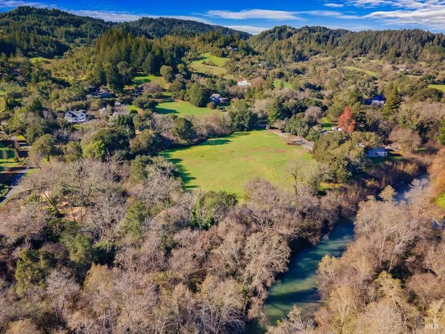 a view of a yard with wooden fence