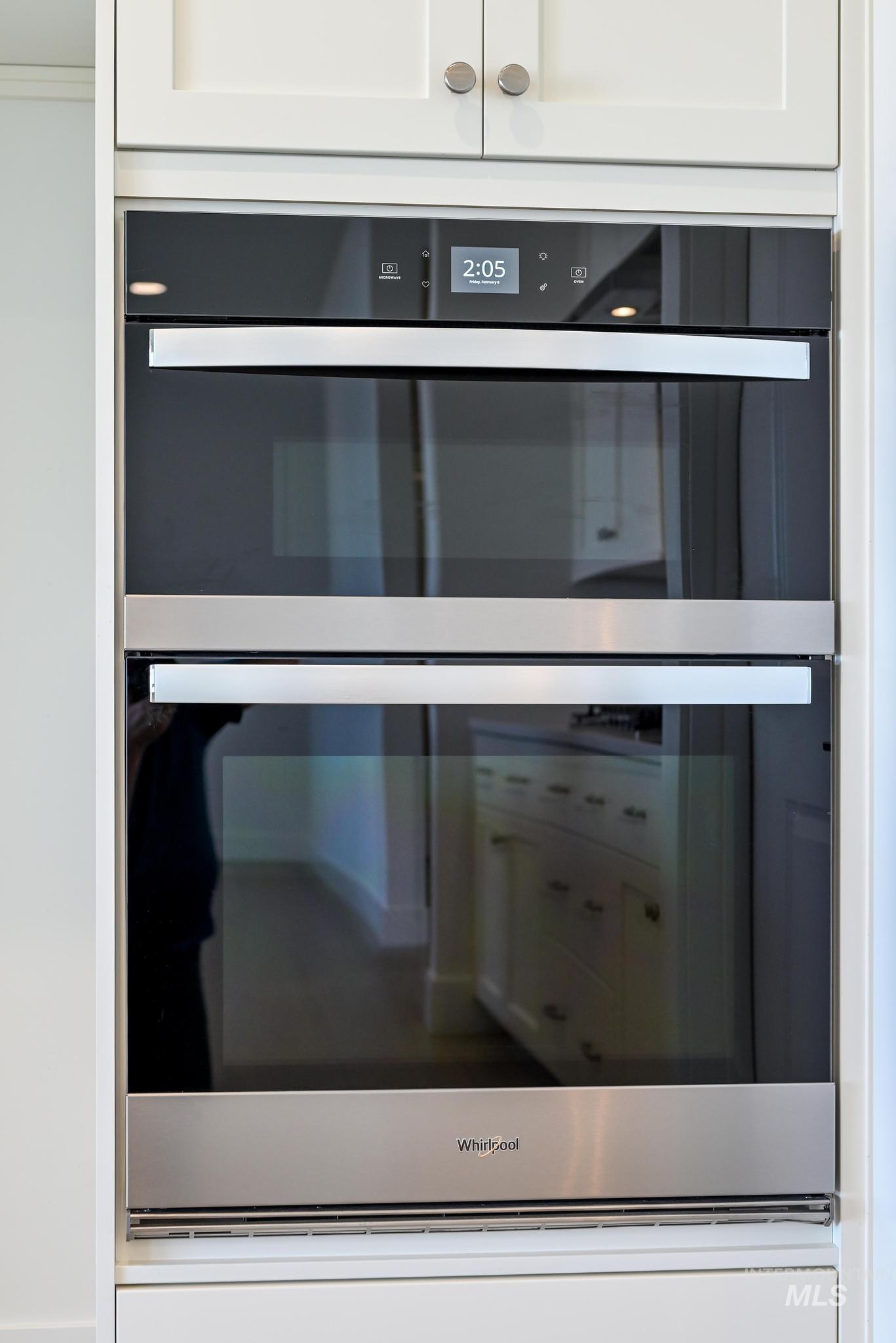 8501 South Country Wind Avenue Meridian, ID 83642 - Photo 11 of 38 Kitchen view of double oven and white cabinets