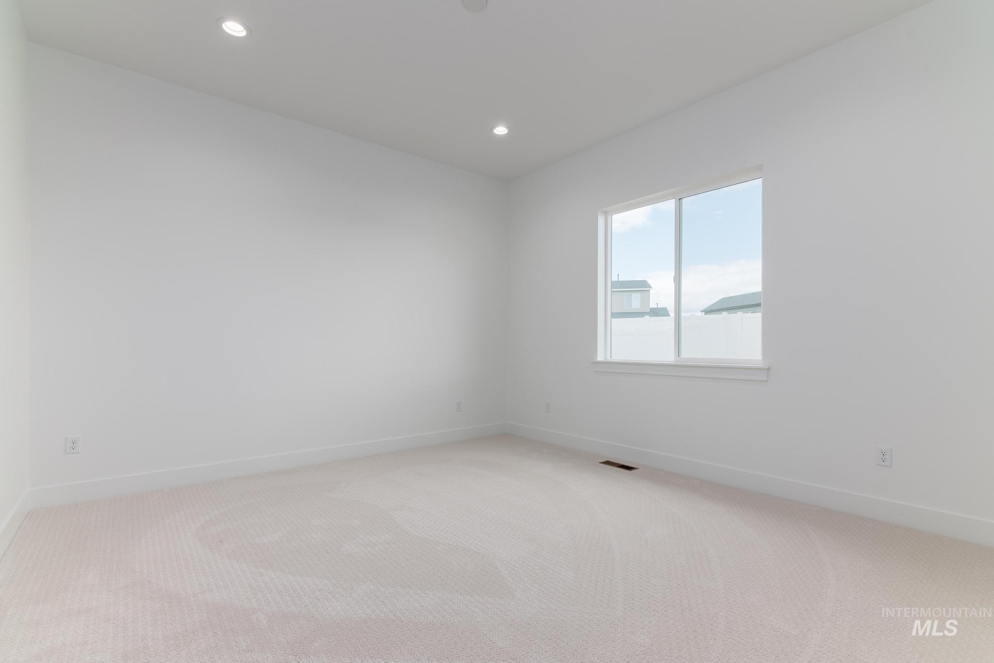 8501 South Country Wind Avenue Meridian, ID 83642 - Photo 16 of 38 Carpeted spare room with recessed lighting and baseboards