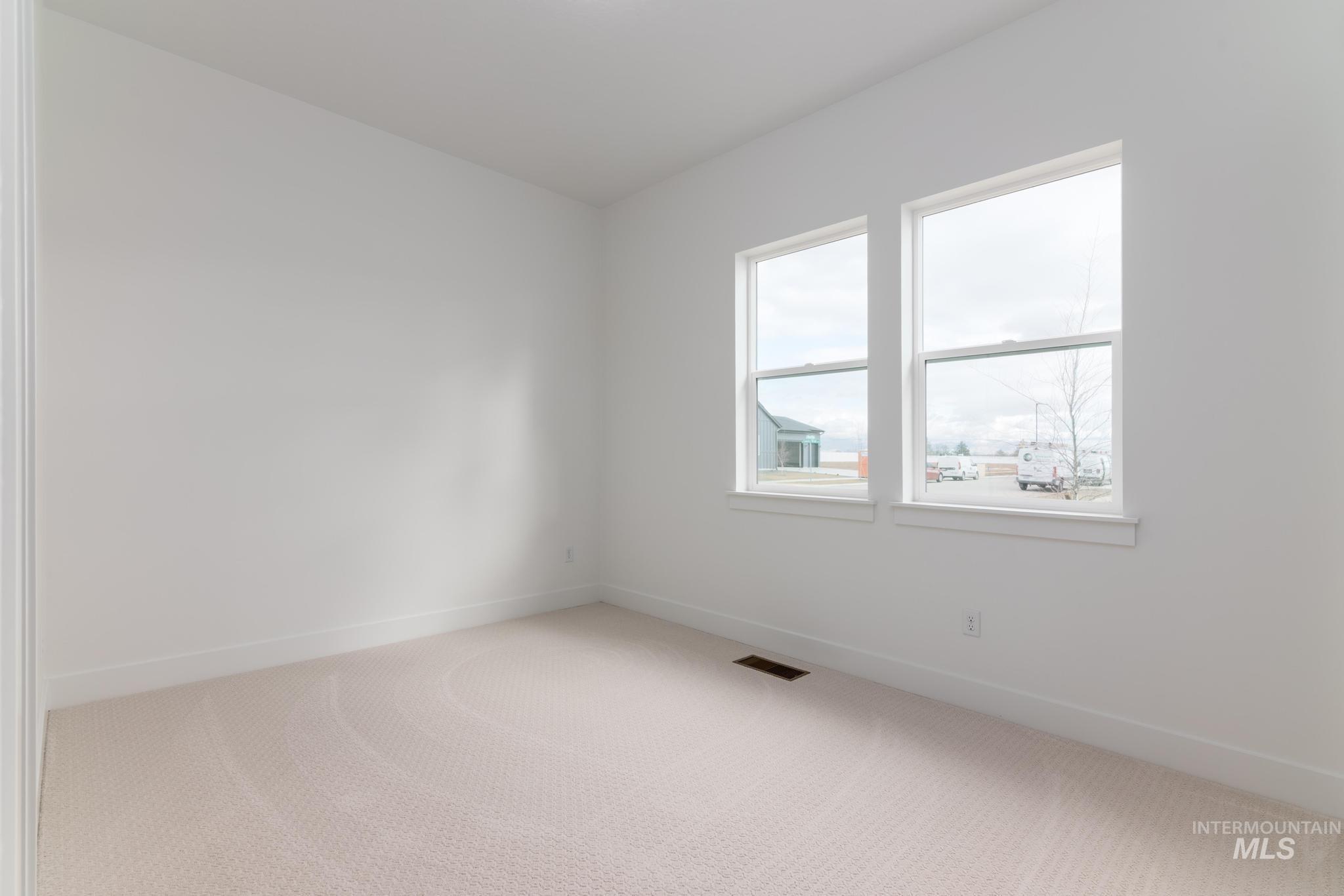 8501 South Country Wind Avenue Meridian, ID 83642 - Photo 21 of 38 Empty room featuring light carpet and baseboards