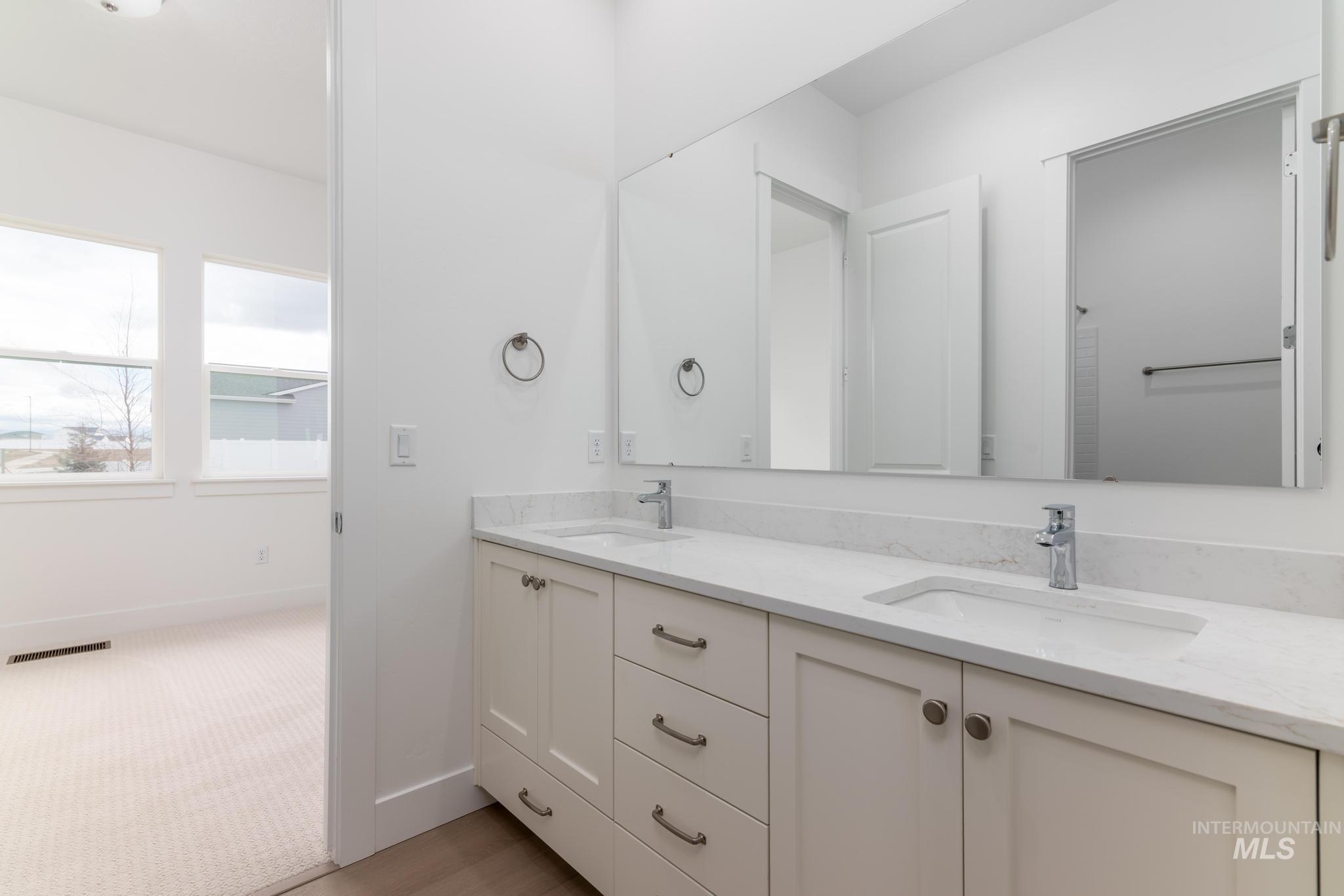 8501 South Country Wind Avenue Meridian, ID 83642 - Photo 22 of 38 Bathroom featuring double vanity and baseboards