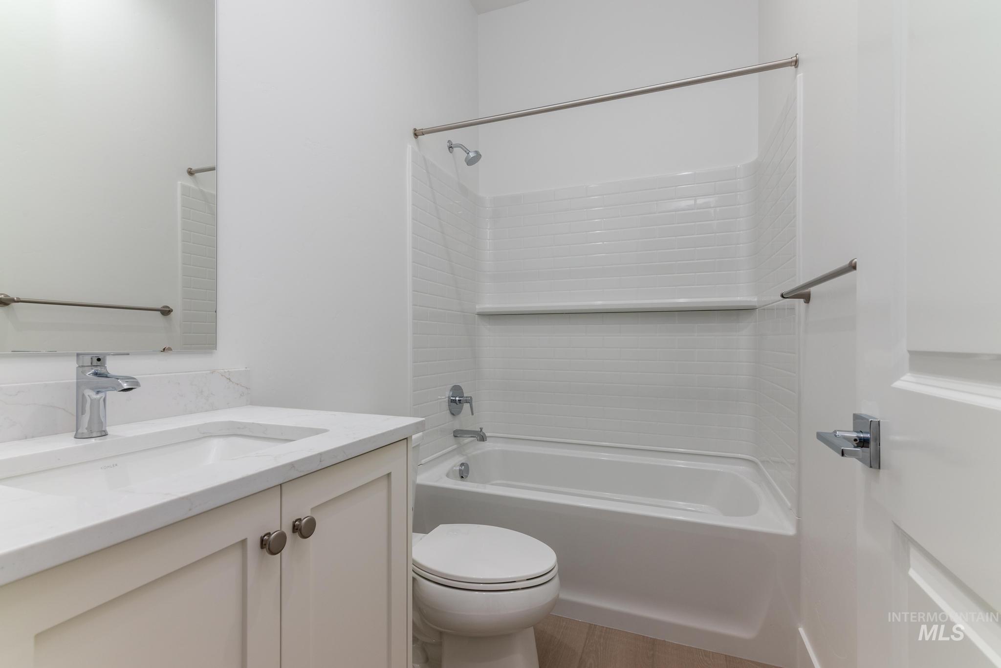 8501 South Country Wind Avenue Meridian, ID 83642 - Photo 24 of 38 Full bathroom with vanity, bathtub / shower combination, and light wood-type flooring