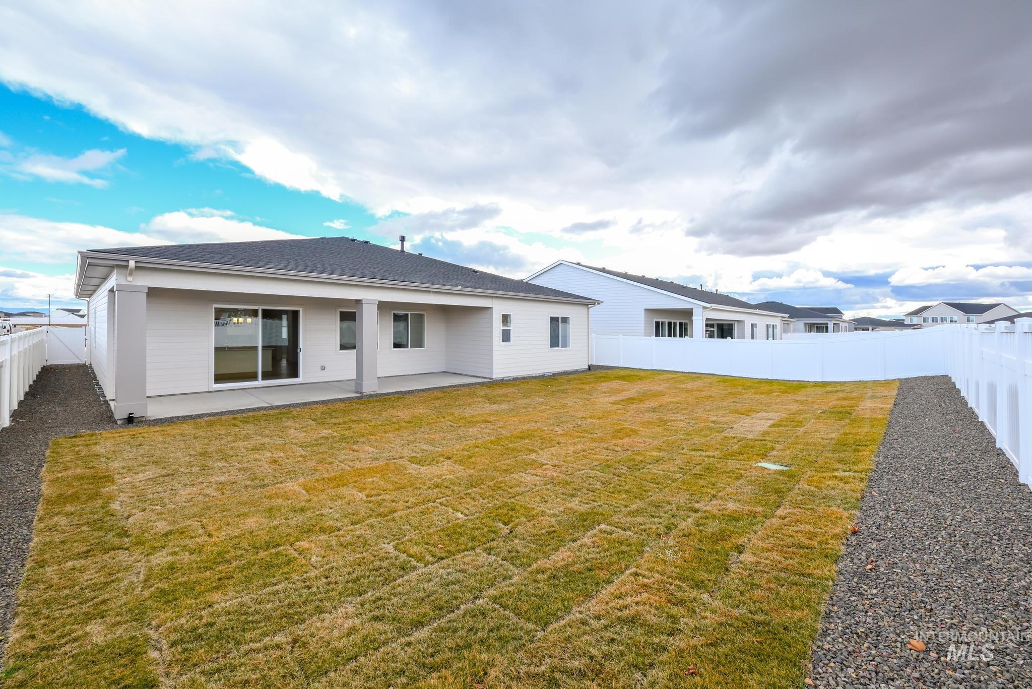 8501 South Country Wind Avenue Meridian, ID 83642 - Photo 26 of 38 Rear view of house with a fenced backyard and a patio area