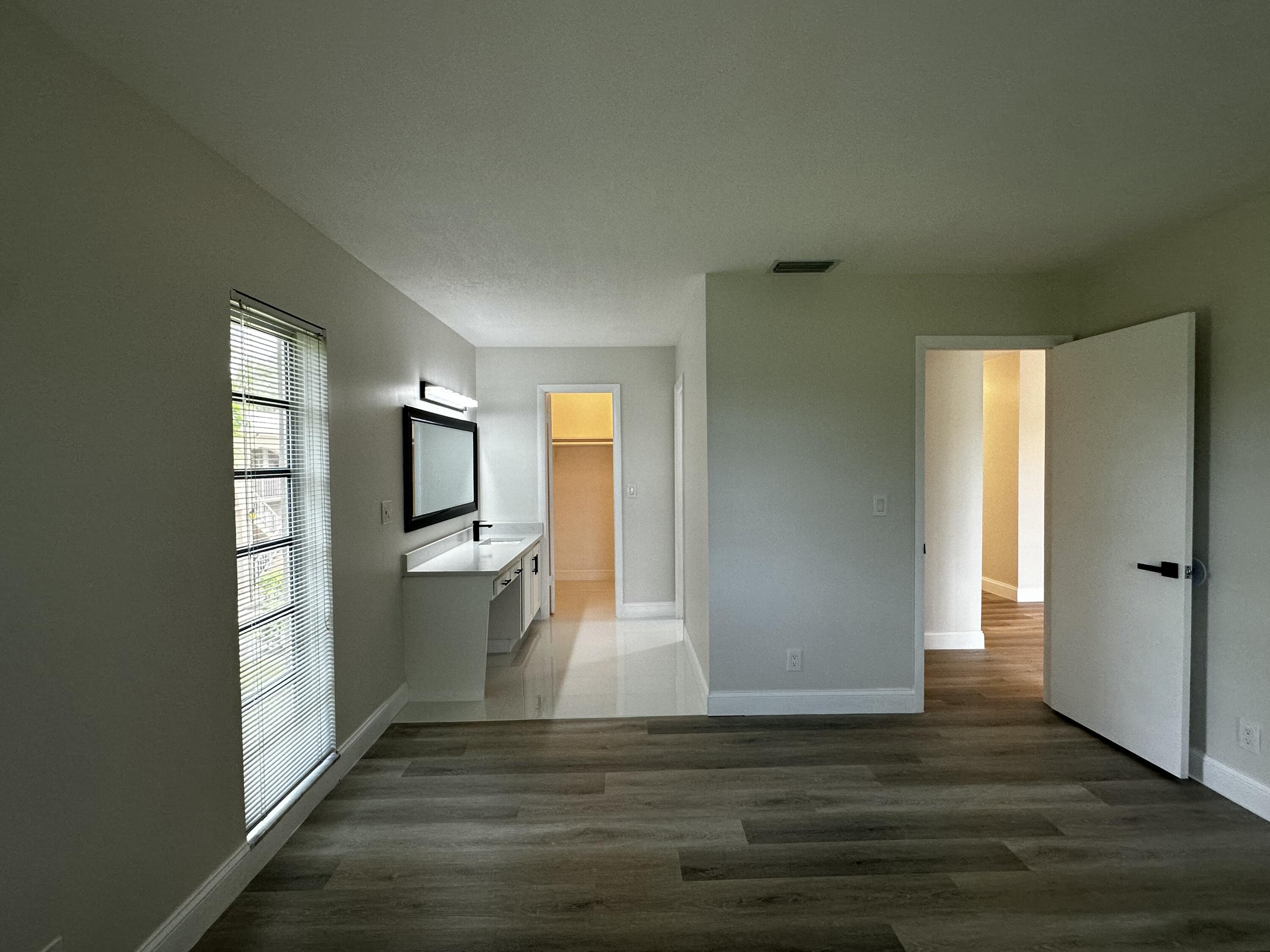 13682 Vía Flora, Unit H Delray Beach, FL 33484 - Photo 19 of 28 a view of a kitchen with a sink and refrigerator
