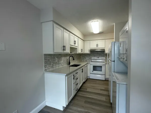 a kitchen with stainless steel appliances granite countertop a stove and a refrigerator