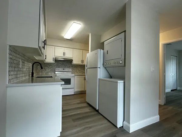 a kitchen with a refrigerator sink and stove