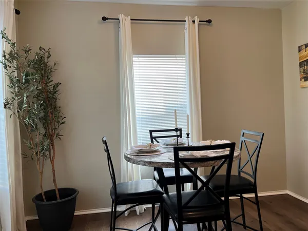 a dining room with furniture and window