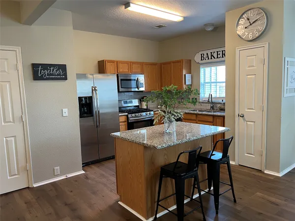 a kitchen with a table and chairs in it