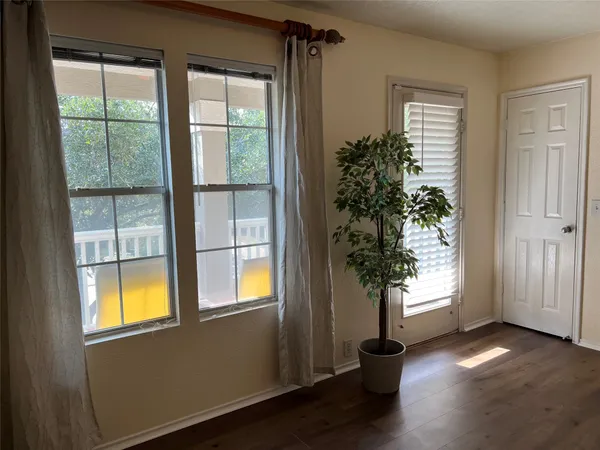 a view of balcony with wooden floor and outdoor seating