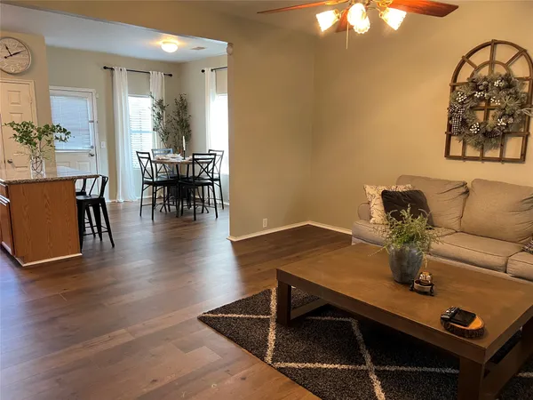 a living room with furniture and wooden floor