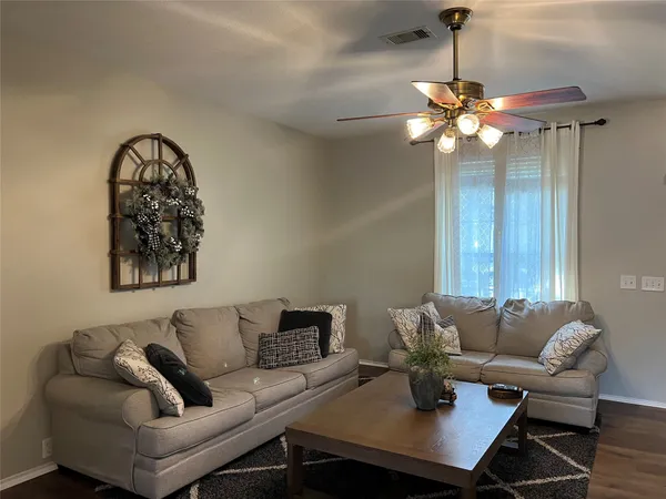 a living room with furniture and a chandelier