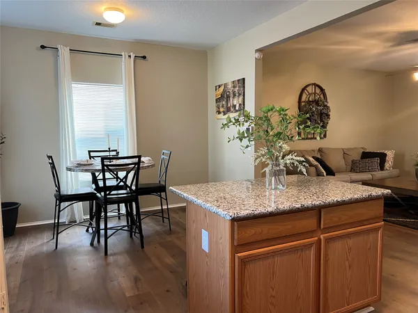 a dining hall with a table and chairs in it