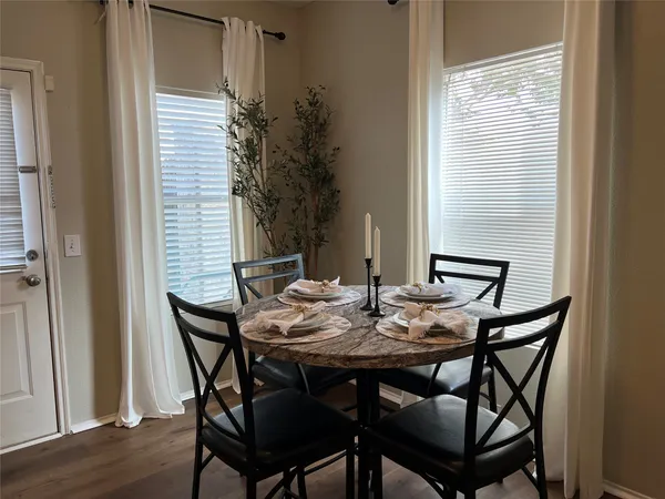 a view of a dining room with furniture and wooden floor
