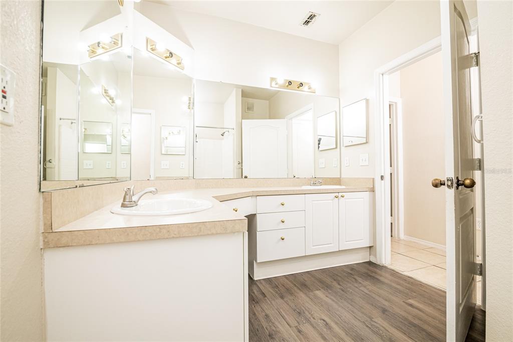 3391 South Kirkman Road, Unit 1216 Orlando, FL 32811 - Photo 22 of 33 a bathroom with a sink and a mirror