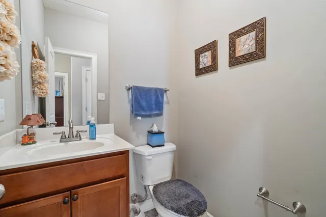 a bedroom with a bed and a flat tv screen on dresser