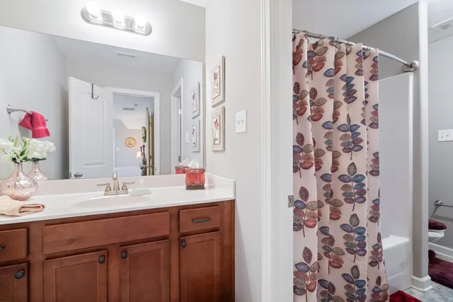 a living room with furniture a ceiling fan and a rug