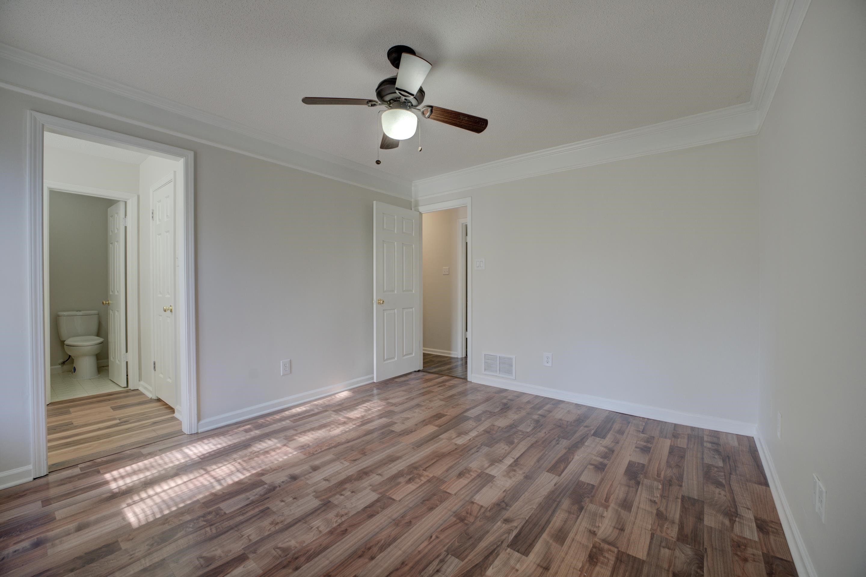 7555 Reese Road Memphis, TN 38133 - Photo 11 of 22 Unfurnished bedroom with ensuite bath, ceiling fan, hardwood / wood-style floors, and ornamental molding