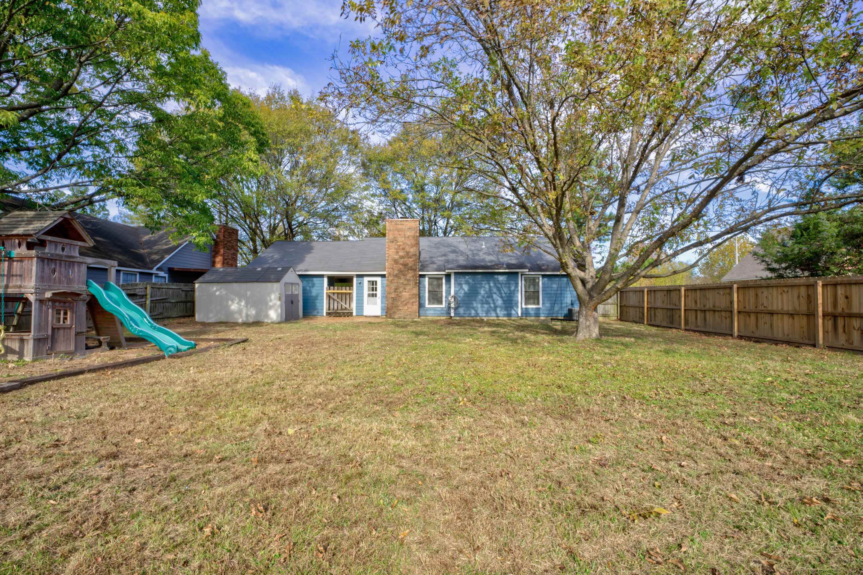 7555 Reese Road Memphis, TN 38133 - Photo 20 of 22 Rear view of property with a playground and a lawn