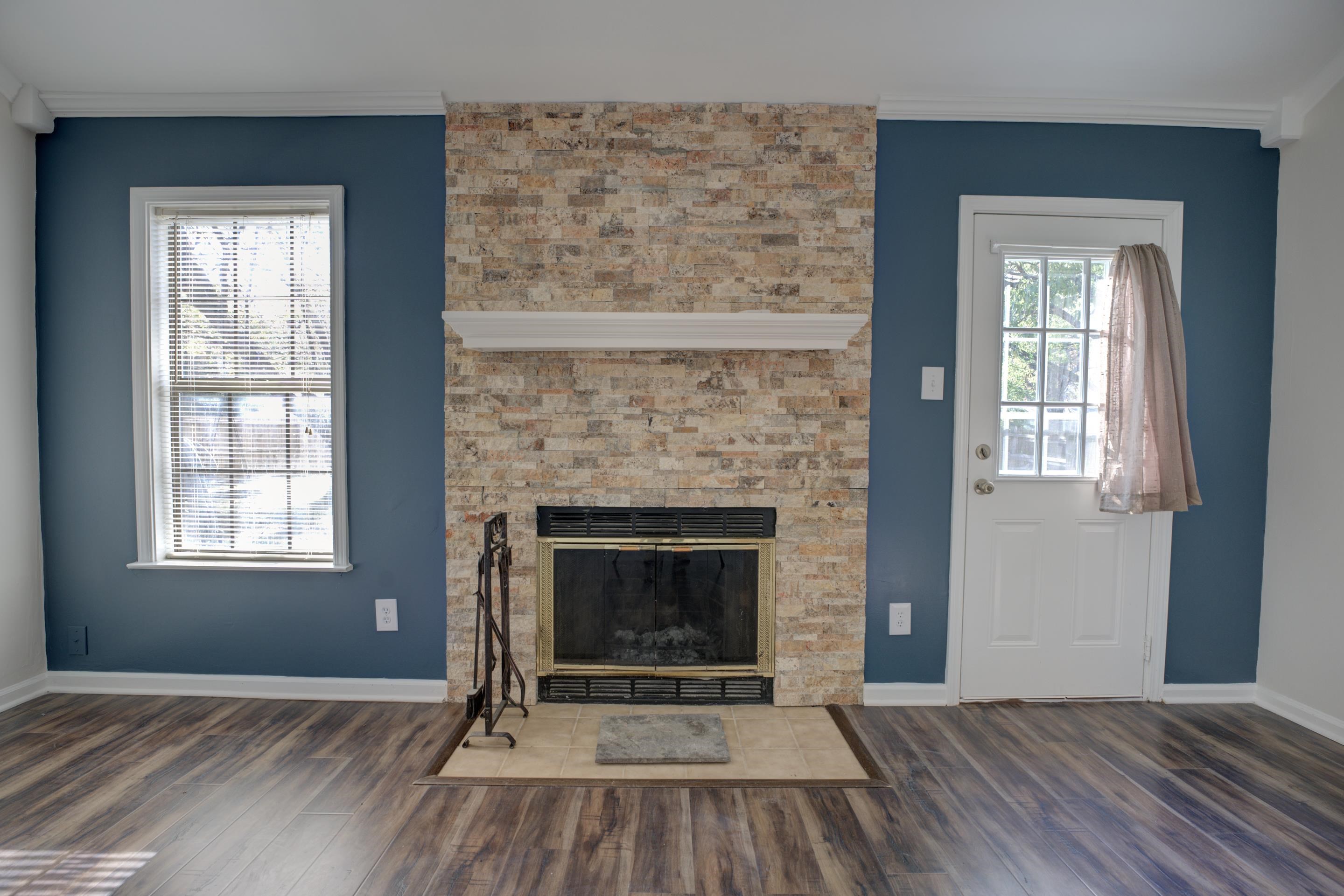7555 Reese Road Memphis, TN 38133 - Photo 6 of 22 Unfurnished living room with a tile fireplace, dark hardwood / wood-style flooring, plenty of natural light, and ornamental molding