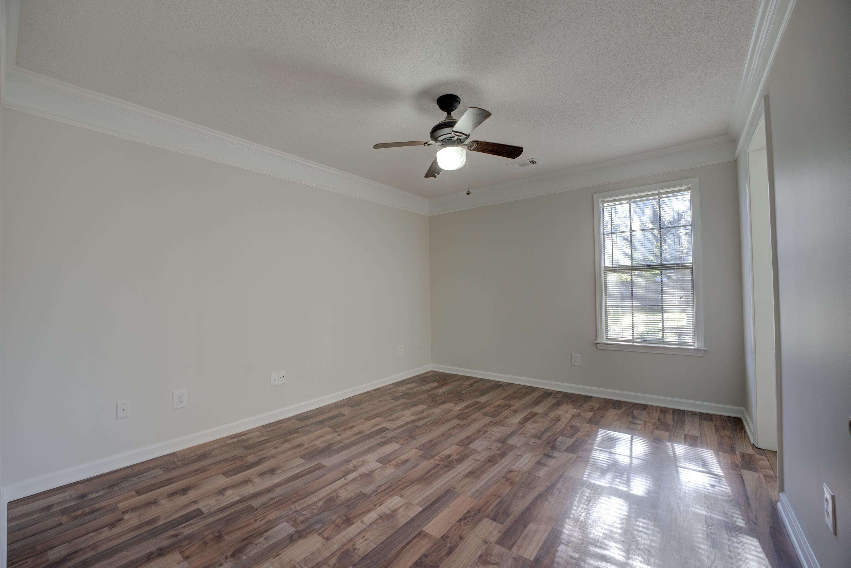 7555 Reese Road Memphis, TN 38133 - Photo 10 of 22 Spare room with a textured ceiling, dark hardwood / wood-style floors, ceiling fan, and crown molding