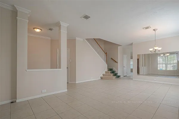 an empty room with windows and entryway