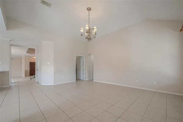 a view of an empty room with chandelier