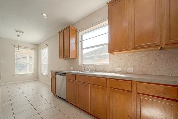 a kitchen with a sink cabinets and window